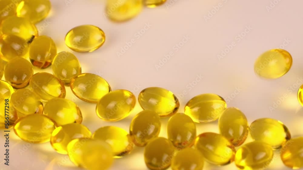 Lots of vitamin D3 capsules, omega 3 pills with fatty acid and vitamin D falling down, soft gel capsules, pharmaceutical nutrition supplement, close up slow motion video clip. 4k footage Lots of vitamin D3 capsules, omega 3 pills with fatty acid and vitamin D falling down, soft gel capsules, pharmaceutical nutrition supplement, close up slow motion video clip. 4k footage