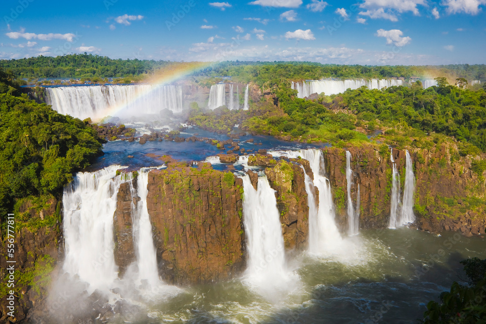 Overview of a rainbow arching over the iconic Iguazu Falls, Iguazu Falls National Park; Parana, Brazil Overview of a rainbow arching over the iconic Iguazu Falls, Iguazu Falls National Park; Parana, Brazil