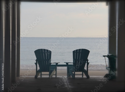 two adirondack chairs  on the beach