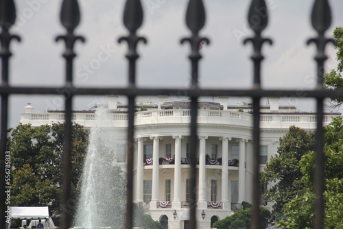 whitehouse  and water fountain through iron gate