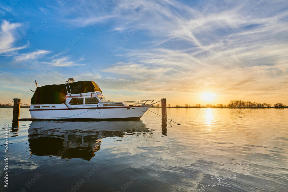 A boat moored on Donau River at sunset; Upper Palatinate, Bavaria, Germany A boat moored on Donau River at sunset; Upper Palatinate, Bavaria, Germany
