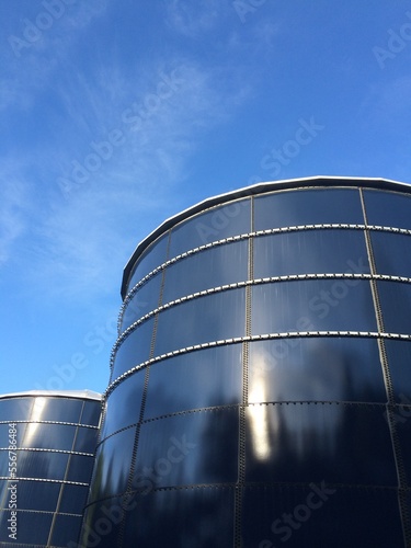 blue water tanks with sky