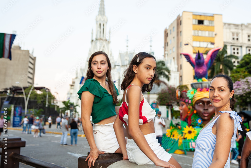 Fototapeta premium Tourists at the River Boulevard with La Ermita church on background in the city of Cali in Colombia. Christmas decoration.