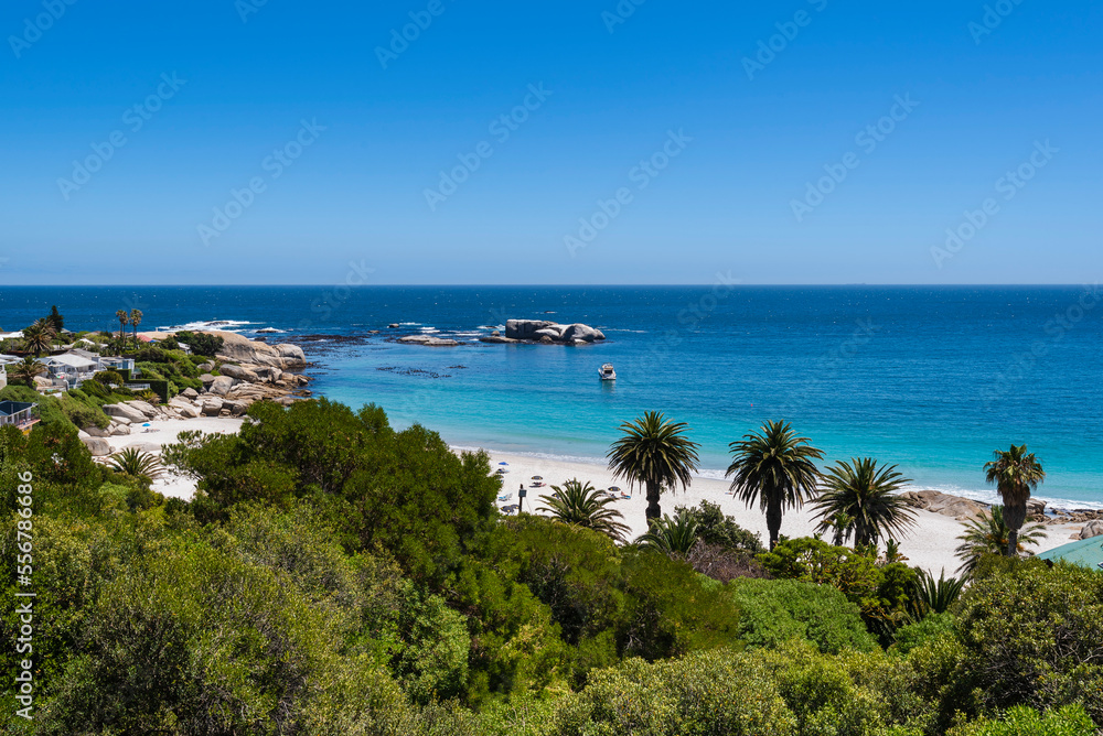Overview of tropical vegetation and rocky shore with beachfront homes along the Atlantic Ocean at Clifton Beach; Cape Town, Western Cape, South Africa Overview of tropical vegetation and rocky shore with beachfront homes along the Atlantic Ocean at Clifton Beach; Cape Town, Western Cape, South Africa