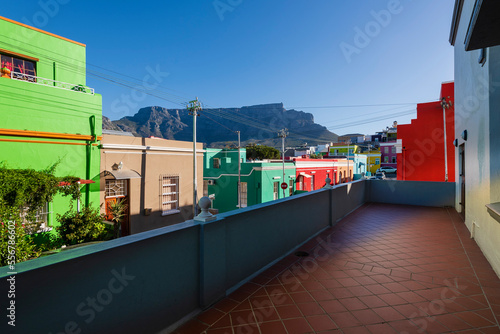 Colorful heritage houses on Wale Street in the Bo-Kaap District with Table Mountain in the Background; Cape Town, Western Cape, South Africa photo