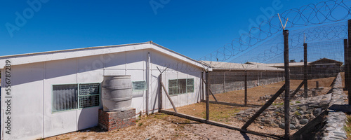 Barbed wire fence and buildings at Robben Island Prison; Robben Island, Cape Town, Western Cape Province, South Africa photo