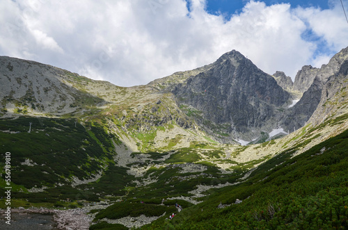 Skalnate pleso at the lowest corrie of the Rocky Valley and peak of Lomnicky Stit at the National park High Tatras, Slovakia photo