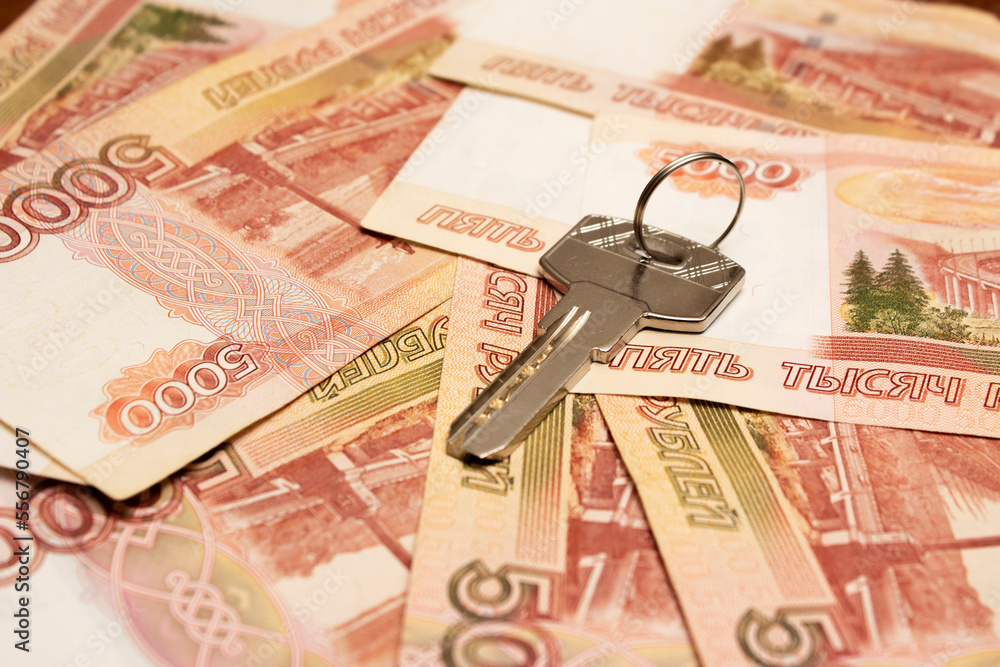 Metal key on stack of paper red banknotes of 5000 Russian rubles. Ruble. Five thousand. Concept of buying an apartment in mortgage, renting real estate. Loan for purchase of room. Cash money. Banknote Metal key on stack of paper red banknotes of 5000 Russian rubles. Ruble. Five thousand. Concept of buying an apartment in mortgage, renting real estate. Loan for purchase of room. Cash money. Banknote