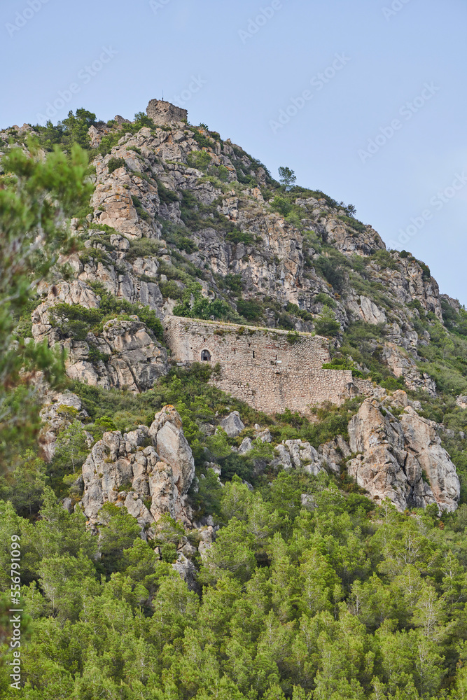 Old, stone built structure in the cliffs on a mountainside in morning light, Parc Natural dels Ports; Catalonia, Spain Old, stone built structure in the cliffs on a mountainside in morning light, Parc Natural dels Ports; Catalonia, Spain