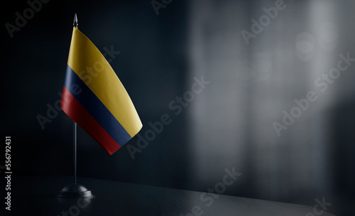 Small national flag of the Colombia on a black background