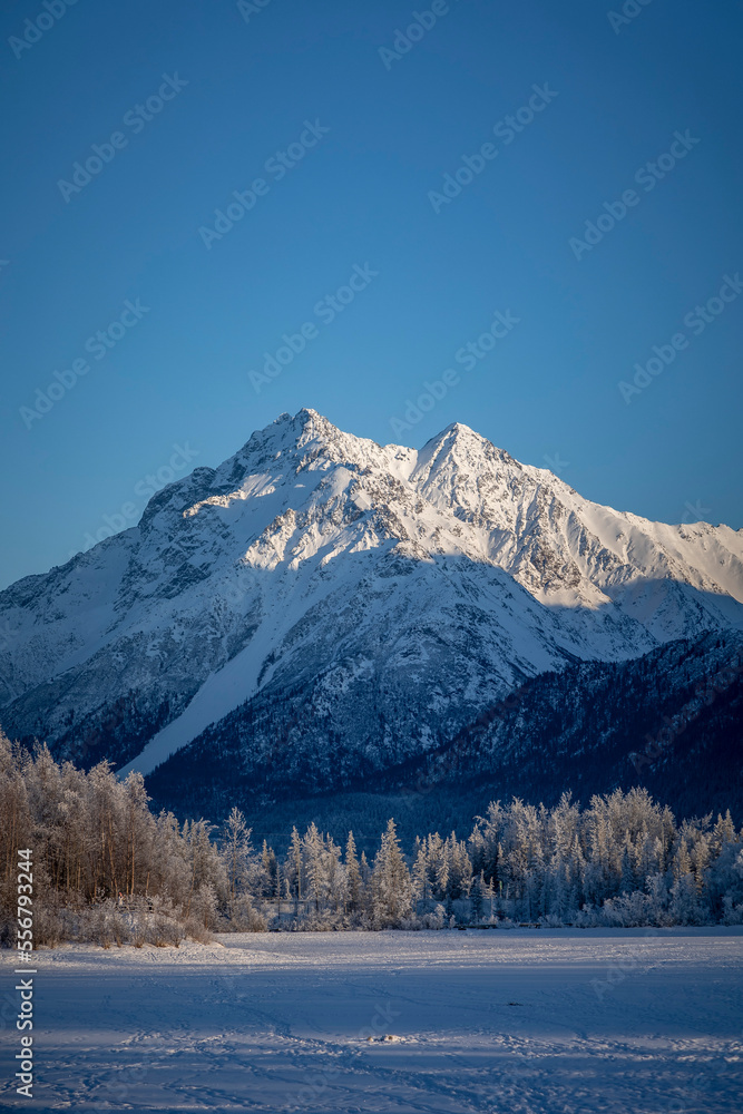 Sunlit, snow covered mountaintop of Pioneer Peak in the Chugach Mountains; Palmer, Alaska, United States of America Sunlit, snow covered mountaintop of Pioneer Peak in the Chugach Mountains; Palmer, Alaska, United States of America
