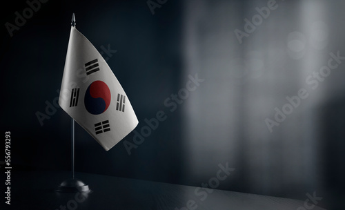 Small national flag of the South Korean on a black background