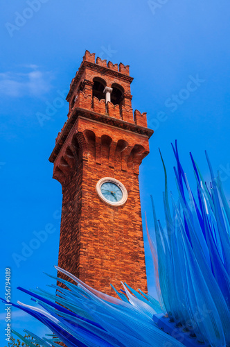 Clock tower (Campanile Santo Stefano) and Comet Glass Stars sculpture (Cometa di Vetro) in Campo Santo Stefano on Murano Island in Veneto; Murano, Venice, Italy photo