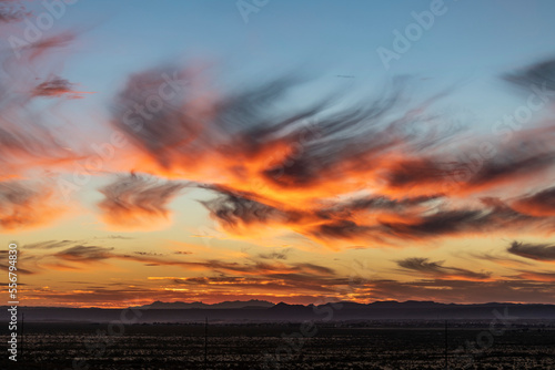 A sunset near Las Cruces, New Mexico with glowing cirrus clouds showing Virga effect; Las Cruces, New Mexico, United States of America photo