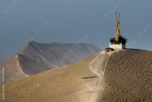 Tower of Buddhist prayer flags on a sandy mountaintop at Labrang; Labrang, Amdo, Tibet photo