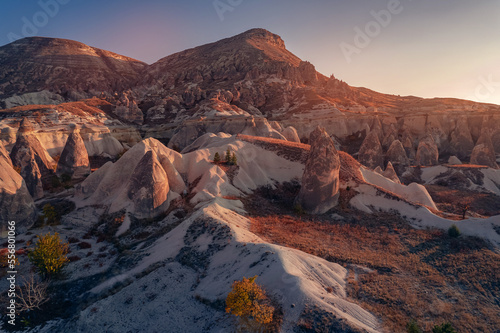 Panoramic view of Goreme national park with over deep canyons, valleys sunset Cappadocia sunset. Popular Turkey touristic place, aerial top view drone