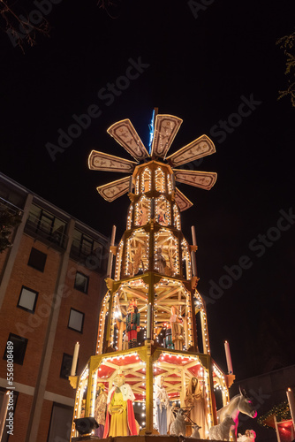 Christmas pyramid, Weihnachtspyramide, attractive decorated Christmas market art and structure, combination of wooden pyramidal outer frame, central carousel  and figures of nativity scenes. photo