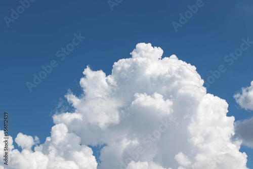 White cumulus clouds in the blue sky, illuminated by the bright spring sun.