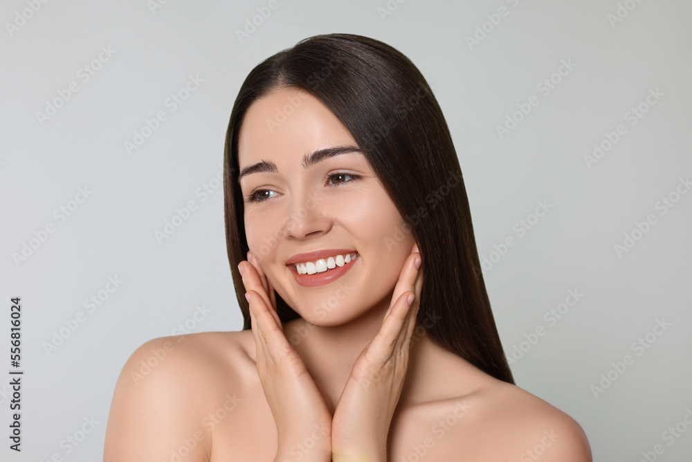 Portrait of attractive young woman on light grey background. Spa treatment Portrait of attractive young woman on light grey background. Spa treatment