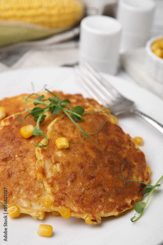 Tasty corn pancakes on white plate, closeup Tasty corn pancakes on white plate, closeup