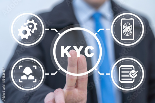 Businessman using virtual touchscreen presses abbreviation: KYC. Concept of KYC Know Your Customer. Identification bank client, analysis risk and trust business, anti laundering. E-KYC technology. photo