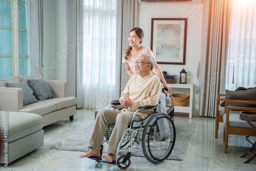 Caregiver woman comforting senior man sitting on wheelchair at nursing home,Loving caregiver taking care and express health care sympathy of senior man.