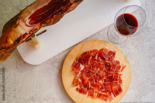 Sliced of Spanish Jamón iberico and red wine glass photo