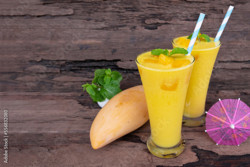 Mango juice fruit smoothies yogurt drink yellow healthy delicious taste in a glass slush for weight loss on wooden background.