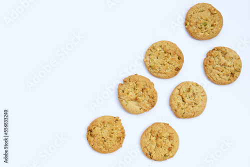 Pistachio and almond cookies on white background.