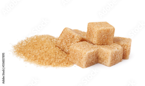 Granulated and cubed brown sugar on white background