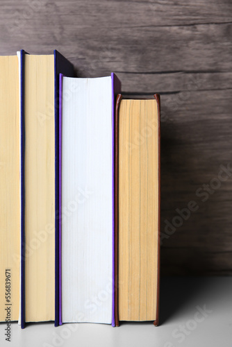 Collection of different books on white shelf  space for text
