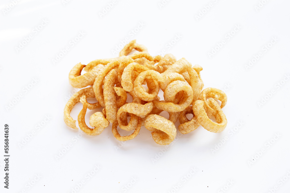 Fried crispy pork rinds on white background. Fried crispy pork rinds on white background.