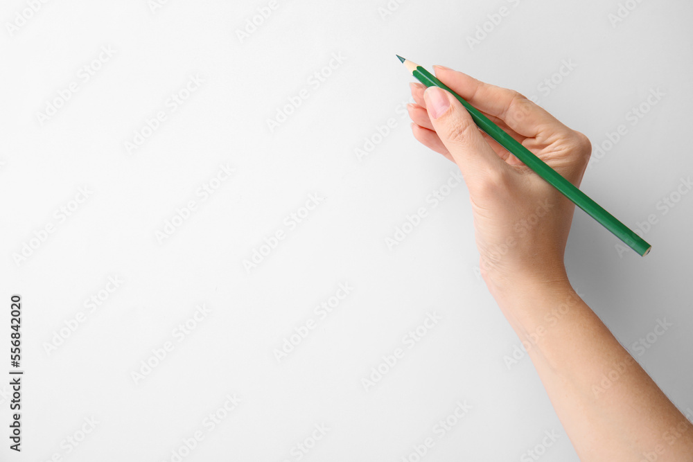 Woman with green pencil on white background, closeup. Space for text Woman with green pencil on white background, closeup. Space for text