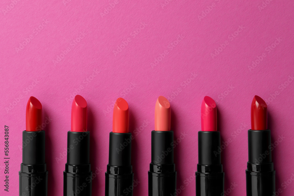 Beautiful lipsticks on pink background, flat lay. Space for text Beautiful lipsticks on pink background, flat lay. Space for text