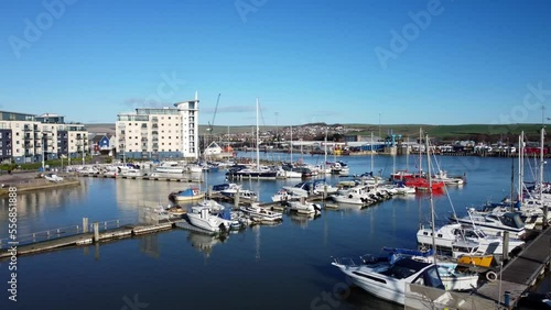 Newhaven marina with yachts and boats docked in summer sun in England photo