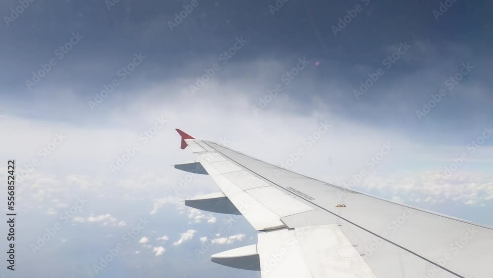 Airliner Wing Between Two Layers Of Clouds Fly in the Blue Sky - Timelapse Airliner Wing Between Two Layers Of Clouds Fly in the Blue Sky - Timelapse