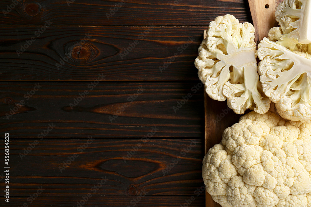 Fresh raw cauliflower on wooden table, top view. Space for text