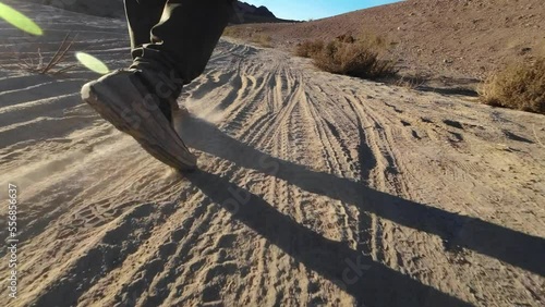 Walking on desert dusty dirt road photo