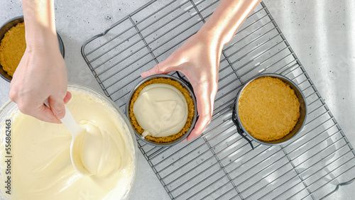 Mini cheesecake recipe. Pouring cheesecake batter into a prepared baking pan, close-up preparation process, view from above