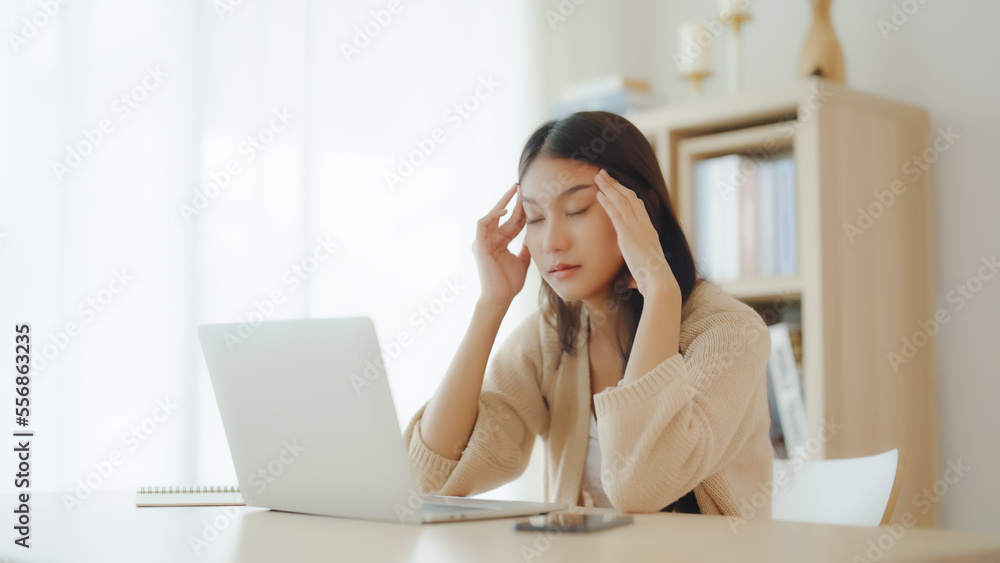 Office syndrome. Overworked tired young asian woman feeling headache, having eyesight problem after computer laptop work. Stressed young woman suffering from fatigue at home Office syndrome. Overworked tired young asian woman feeling headache, having eyesight problem after computer laptop work. Stressed young woman suffering from fatigue at home