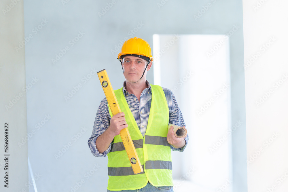 Supervisor male engineer wearing a protective vest and safety hard hat.in construction site for building site survey in civil engineering project. Supervisor male engineer wearing a protective vest and safety hard hat.in construction site for building site survey in civil engineering project.