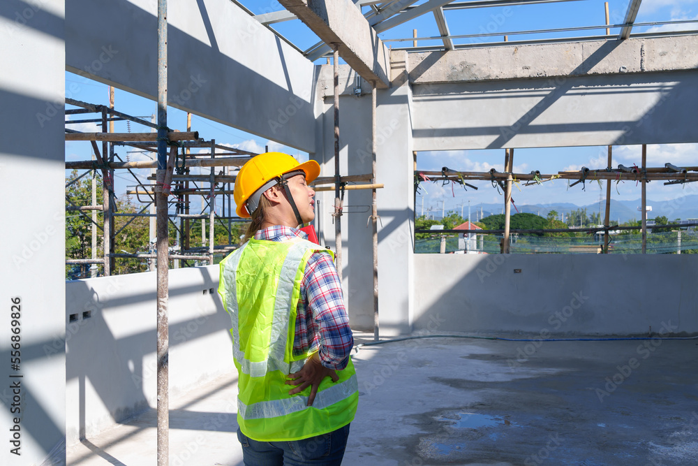 Obraz premium Side view of female engineer using walkie-talkie in construction site for building site survey in civil engineering project.