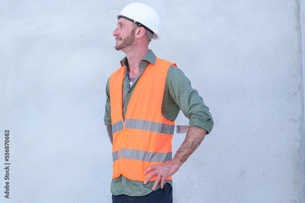 Supervisor male engineer wearing a protective vest and safety hard hat.in construction site for building site survey in civil engineering project. Supervisor male engineer wearing a protective vest and safety hard hat.in construction site for building site survey in civil engineering project.