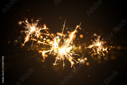 Yellow fireworks on black background with bokeh