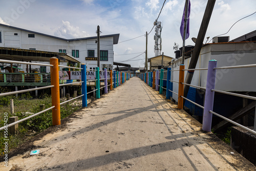 Pulau Ketam, Malaysia - December 26, 2022: Pulau Ketam translated means crab island, It is a small island located off the coast of Klang. Street view of the fisher man village built entirely on stilts © Holger