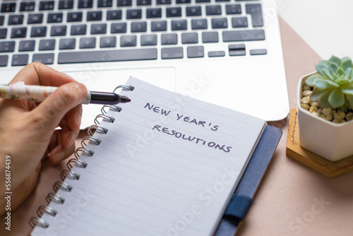 Writing new year's resolution with a black marker on a notebook  photo