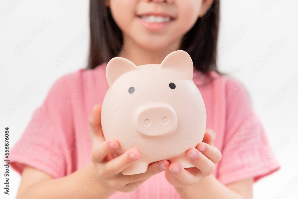 girl hands hold a pink piggy bank . The concept of saving money or savings, investment girl hands hold a pink piggy bank . The concept of saving money or savings, investment