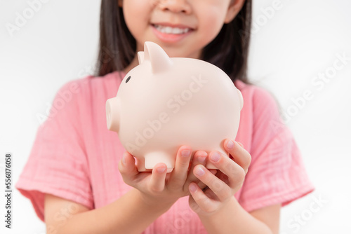 girl hands hold a pink piggy bank . The concept of saving money or savings, investment