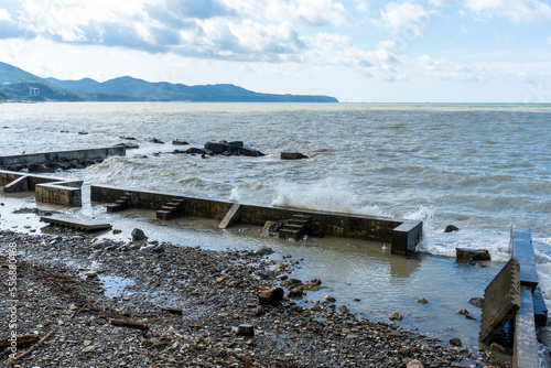 the black sea after the storm, brown water and debris on the shore © Liubov