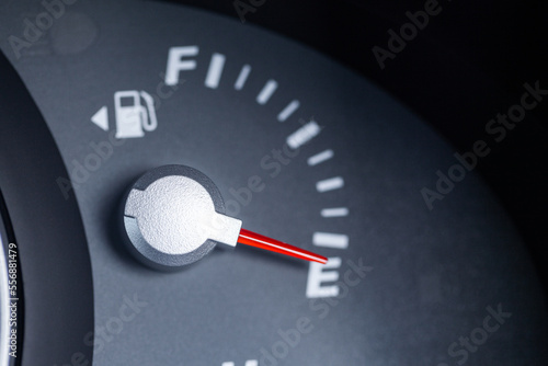 Expensive petrol concept rising cost of living - petrol gauge indicator on empty photo